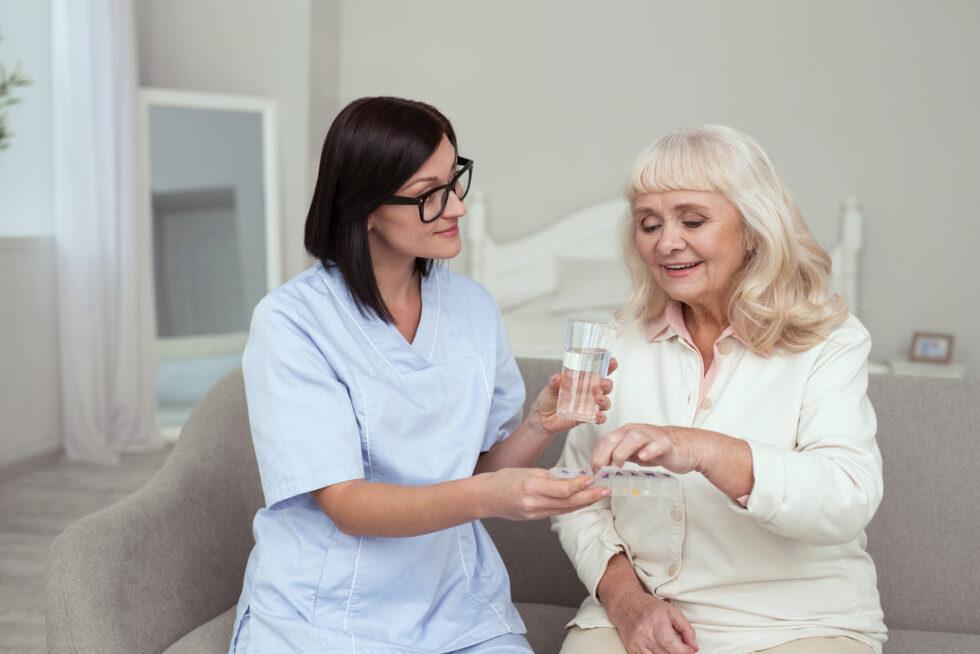 Nurse carefully organizing medications for a senior resident
