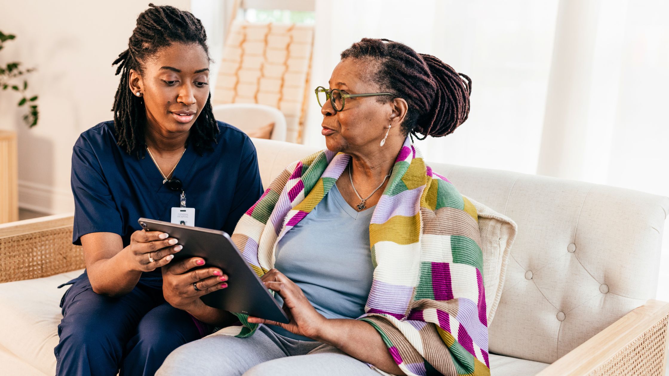 Nurse smiling warmly with elderly patient