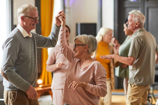 Nurse smiling warmly with an elderly resident in a home-like residential care setting